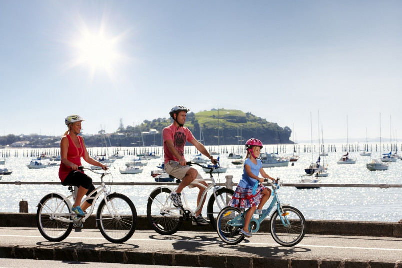 Family cycling along Tamaki Drive, Auckland